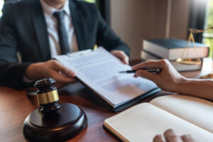 A real estate attorney reviews a lawsuit with their client.